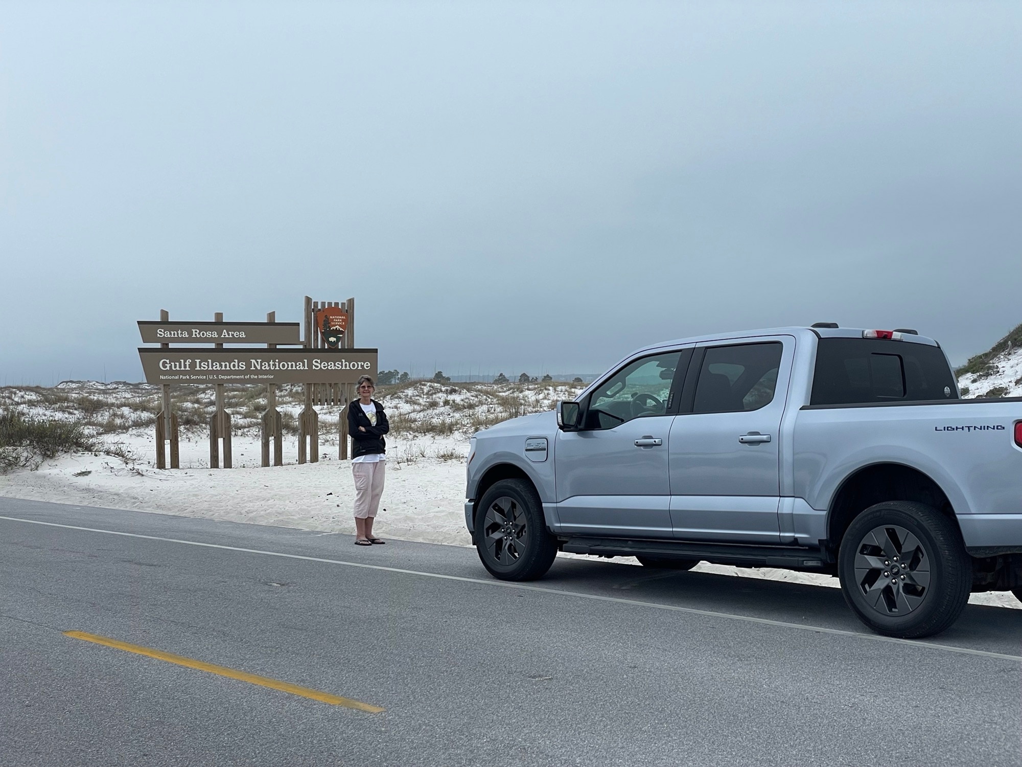 June Eakin and Sherman the F-150® Lightning® at the entrance to Gulf Islands National Seashore.